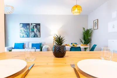 a dining room with a wooden table with plates on it at Formosa Stay IV by YOUR KEY in Funchal