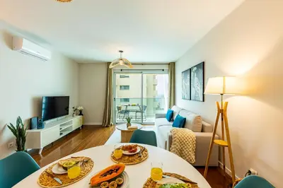 a living room with a table with food on it at Formosa Stay IV by YOUR KEY in Funchal