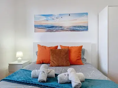 a bedroom with two towels on a bed at Casa Moreira by AH in Caniçal