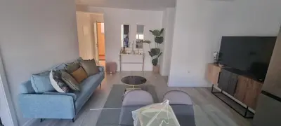a living room with a couch and a tv at Charming little house in Paul do Mar