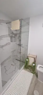 a bathroom with a shower and a toilet at Charming little house in Paul do Mar