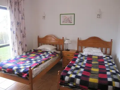 two beds sitting next to each other in a bedroom at Villa Figueira in Figueira