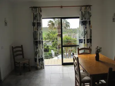 a dining room with a table and a sliding glass door at Villa Figueira in Figueira