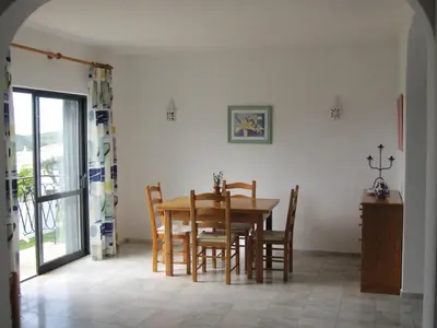 a dining room with a table and chairs at Villa Figueira in Figueira