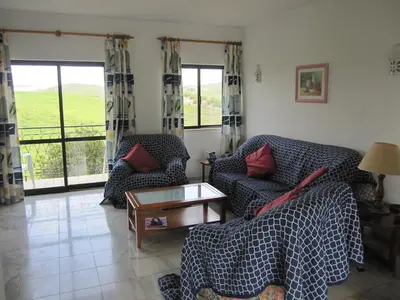 a living room with two couches and a table at Villa Figueira in Figueira
