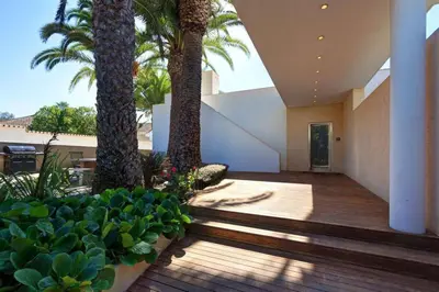 a courtyard with palm trees and plants in a building at Jacaranda Beach Villa in Luz
