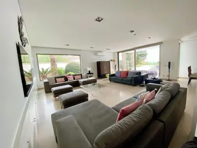 a large living room with couches and chairs at Jacaranda Beach Villa in Luz