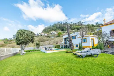 a yard with a pool and a house at Villa Piedade by Homie in Canhas