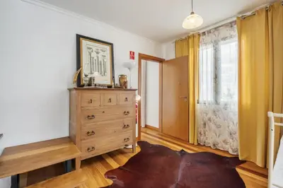 a bedroom with a dresser and a window at Villa Piedade by Homie in Canhas