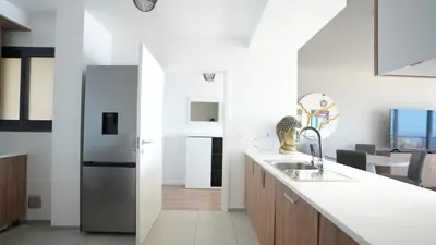 a kitchen with a sink and a counter top at Meeresbrise by LovelyStay in Caniço