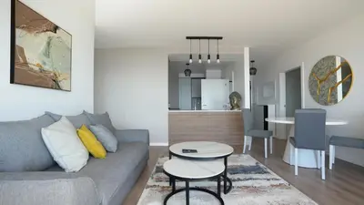 a living room with a couch and a table at Meeresbrise by LovelyStay in Caniço