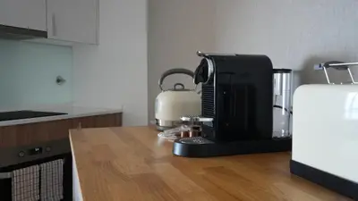 a kitchen with a coffee maker on a counter at Meeresbrise by LovelyStay in Caniço
