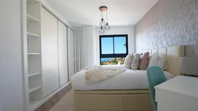 a bedroom with a large bed and a window at Meeresbrise by LovelyStay in Caniço