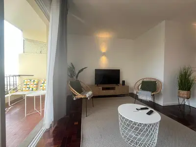 a living room with a television and a table and chairs at Cantinho dos M&M in Funchal