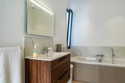 a bathroom with a sink and a bath tub at Casa Luciano in Estreito da Calheta