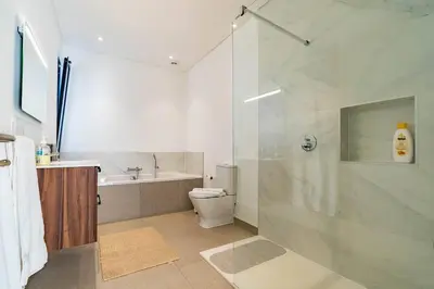 a bathroom with a shower and a toilet and a sink at Casa Luciano in Estreito da Calheta
