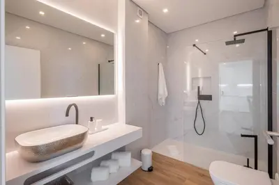 a white bathroom with a sink and a shower at Green Beach Ocean View, Porto de Mós VR13 in Lagos