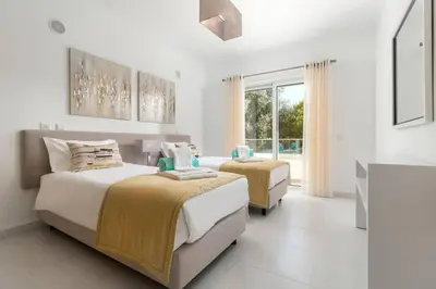 a bedroom with two beds and a window at Home By The Sea Ocean View Apartment in Lagos