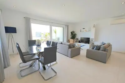 a large living room with a table and chairs at Home By The Sea Ocean View Apartment in Lagos