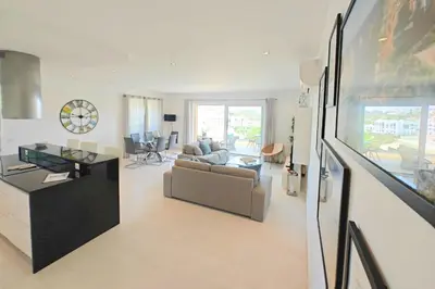 a living room with a couch and a table at Home By The Sea Ocean View Apartment in Lagos