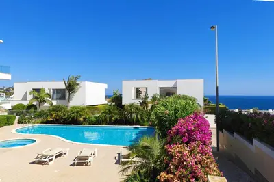 a view of a resort with a swimming pool and the ocean at Home By The Sea Ocean View Apartment in Lagos