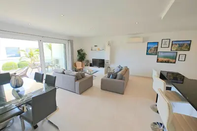 a living room with two couches and a table at Home By The Sea Ocean View Apartment in Lagos
