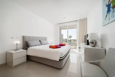 a white bedroom with a bed and a couch at MaBelle Luxury Ocean View Apartment in Lagos