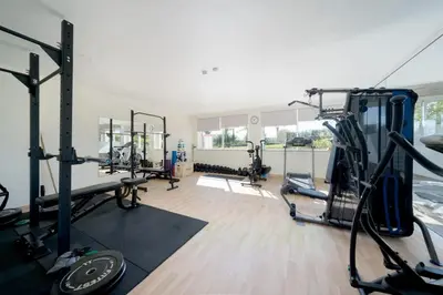 a gym with several tread machines in a room at MaBelle Luxury Ocean View Apartment in Lagos
