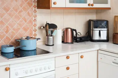 a kitchen counter with pots and pans on a stove at Shabby Chique Surf Beach and Ocean in Luz