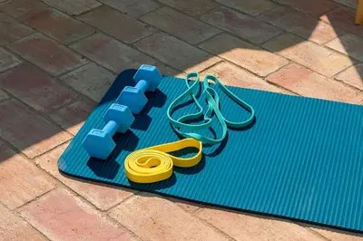 a pair of yellow scissors on a blue mat at Shabby Chique Surf Beach and Ocean in Luz