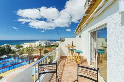 a balcony with a view of the ocean at Shabby Chique Surf Beach and Ocean in Luz
