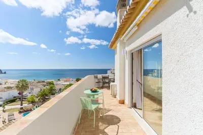 a balcony with a view of the ocean at Shabby Chique Surf Beach and Ocean in Luz