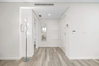 an empty room with white walls and wood floors at Studio Carmo in Funchal