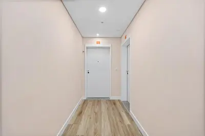 an empty corridor with white walls and a door at Studio Carmo in Funchal