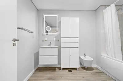 a white bathroom with a sink and a toilet at Studio Carmo in Funchal