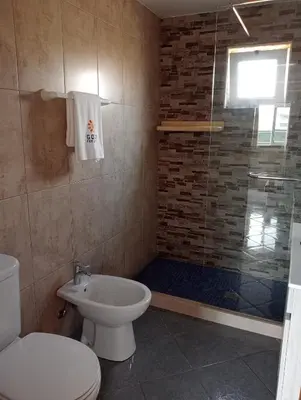 a shower with a shower head in a bathroom at Brisas da Raposeira in Raposeira