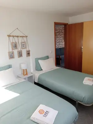 two beds sitting next to each other in a room at Brisas da Raposeira in Raposeira