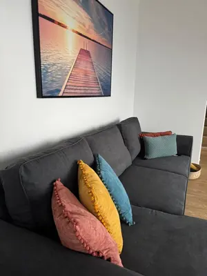a gray couch with colorful pillows in a living room at Calheta Nest in Calheta