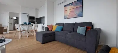a living room with a couch and a dining room at Calheta Nest in Calheta