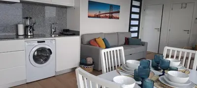 a living room with a washing machine and a couch at Calheta Nest in Calheta
