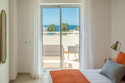 a bedroom with a bed and a view of the ocean at Orange Beach Ocean View, Porto de Mós VR29 in Lagos