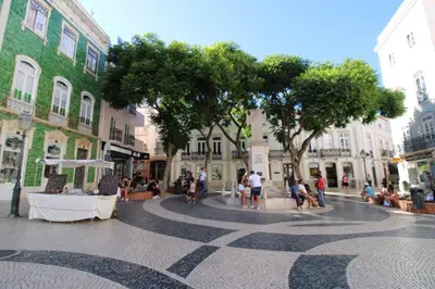 a group of people sitting on a city street at Orange Beach Ocean View, Porto de Mós VR29 in Lagos