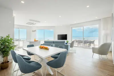 a living room with a table and chairs at Blue Beach Ocean View, Porto de Mós VR14 in Lagos