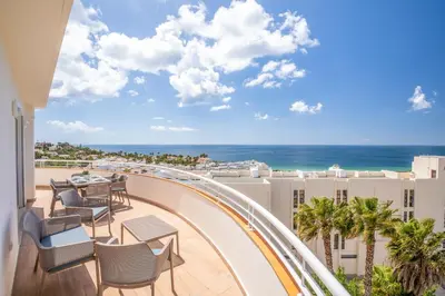a balcony with chairs and a table and the ocean at Blue Beach Ocean View, Porto de Mós VR14 in Lagos