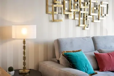 a living room with a couch and a lamp at Exquisite Ocean Apartment by Homie in Caniço