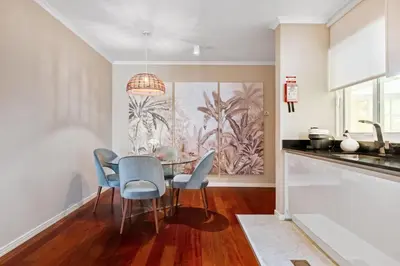 a dining room with a table and blue chairs at Exquisite Ocean Apartment by Homie in Caniço
