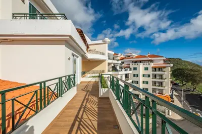 a balcony with a view of buildings at Exquisite Ocean Apartment by Homie in Caniço