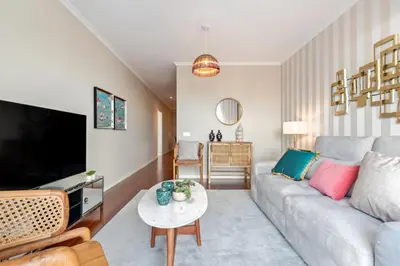 a living room with a couch and a table at Exquisite Ocean Apartment by Homie in Caniço