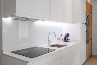 a kitchen with white cabinets and a sink at Yellow Beach Ocean View, Porto de Mós VR38 in Lagos