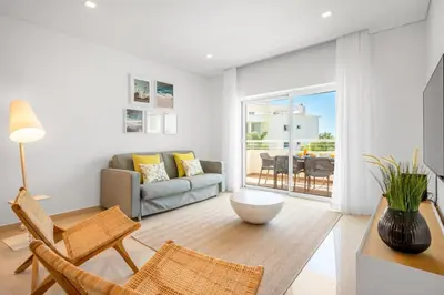 a living room with a couch and a table at Yellow Beach Ocean View, Porto de Mós VR38 in Lagos
